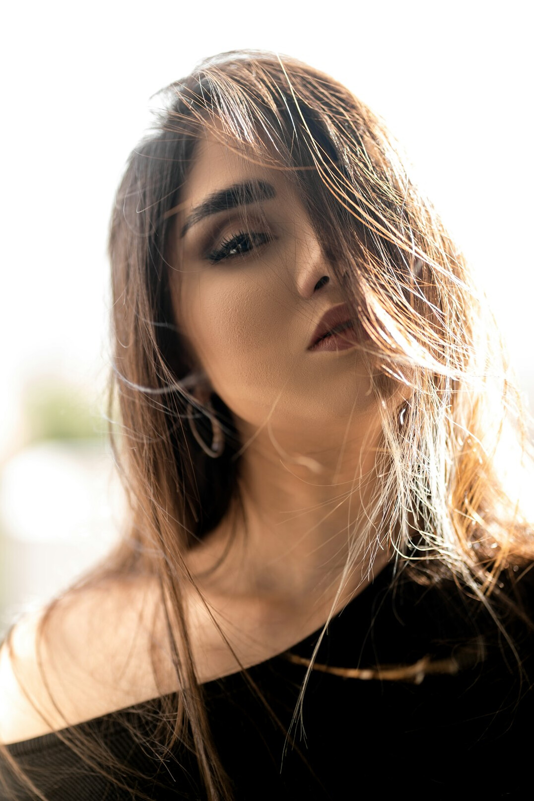 Portrait of a woman with long hair looking at the camera